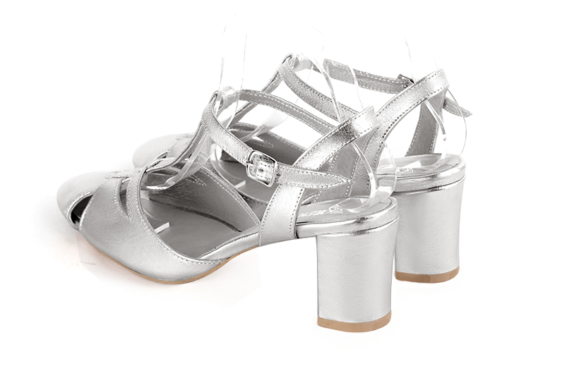 Light silver women's open back T-strap shoes. Round toe. Medium block heels. Rear view - Florence KOOIJMAN